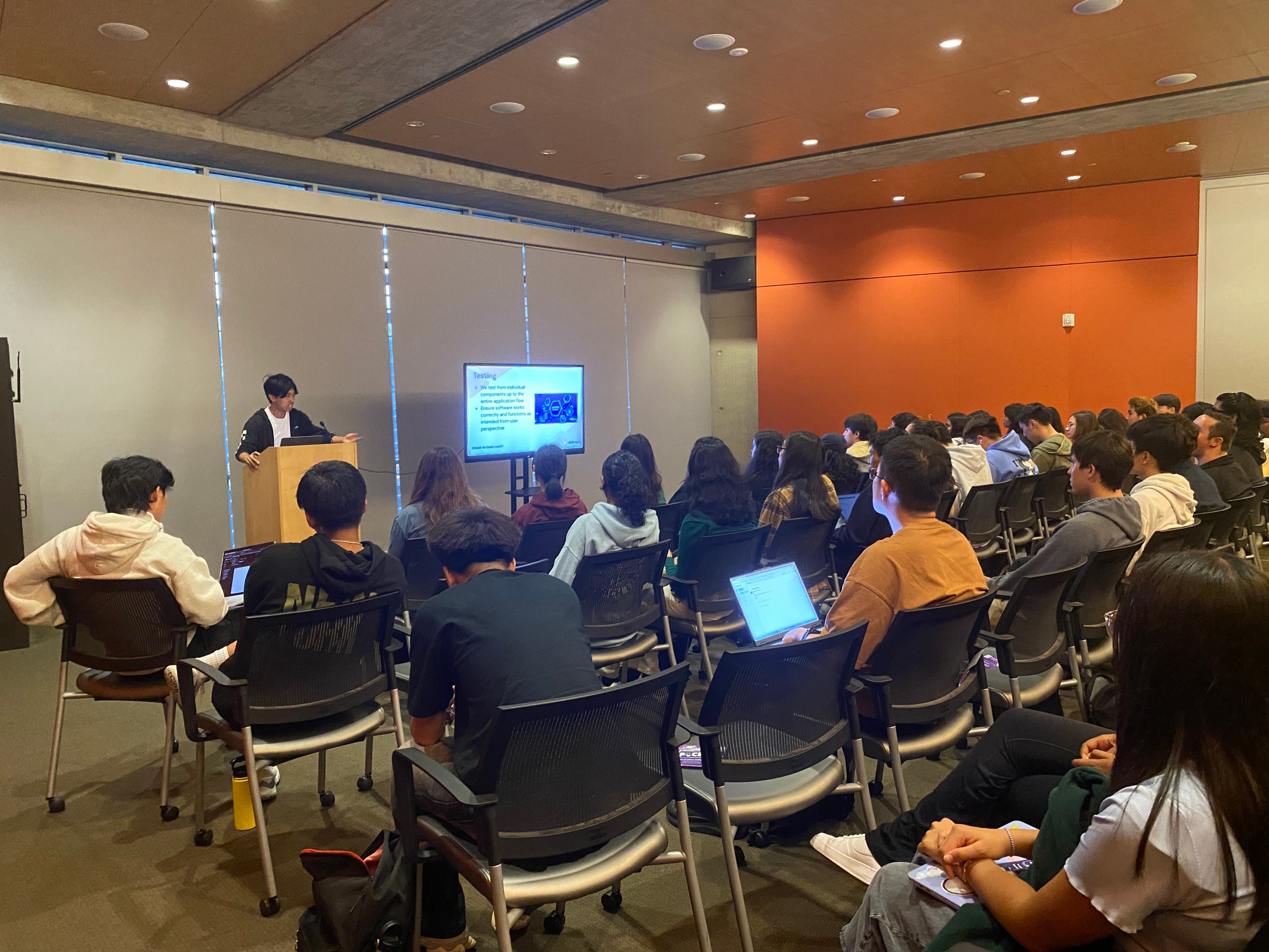 members watch presentation at a Hack Event