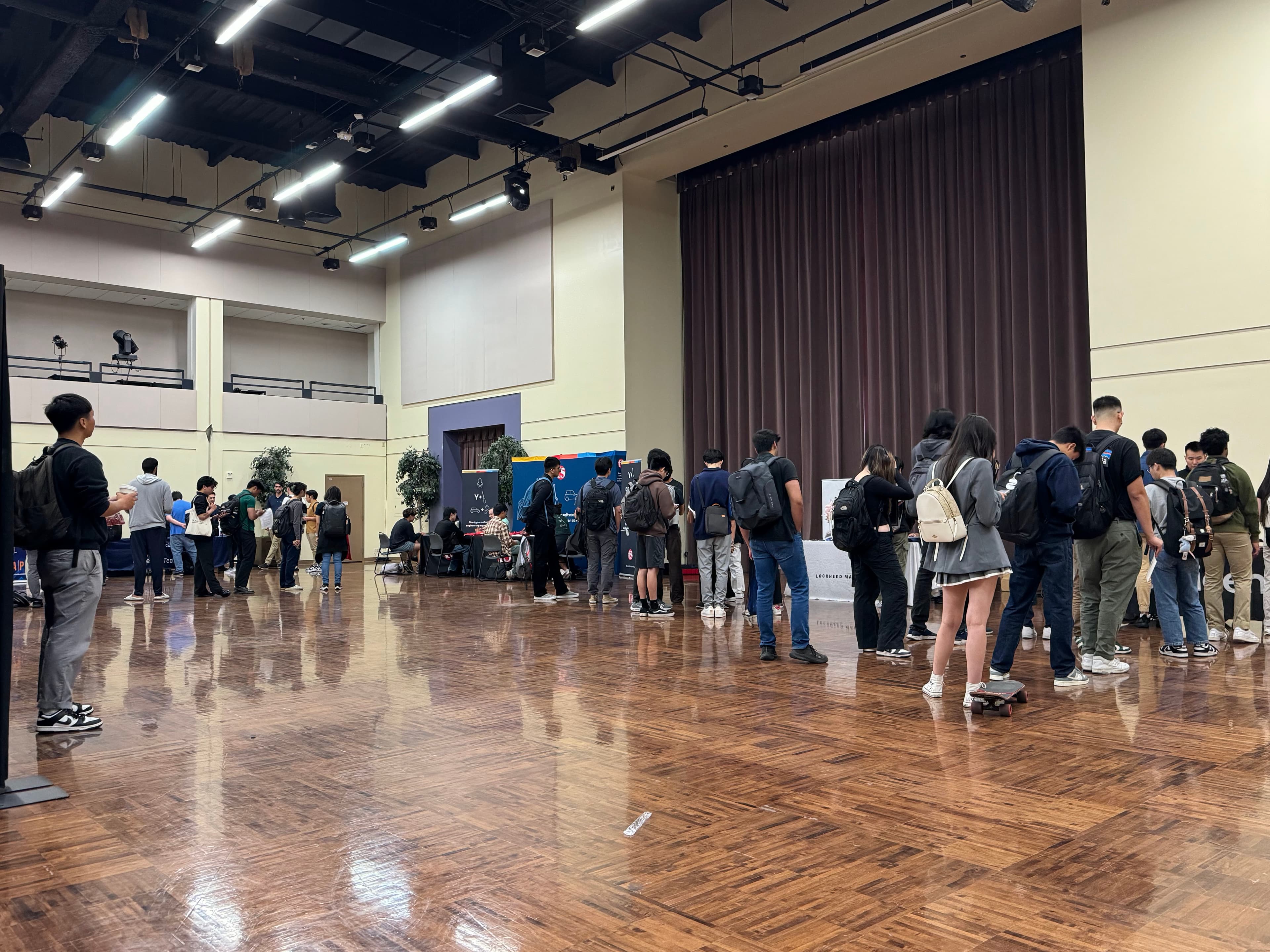 students excitedly await their turn to present themselves to companies